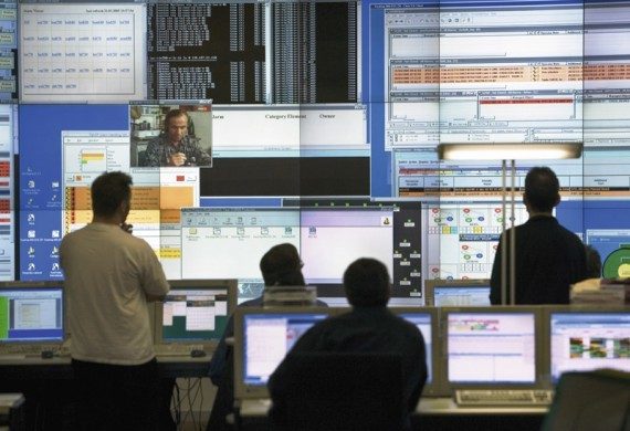 Technical service staff looking at computer screens